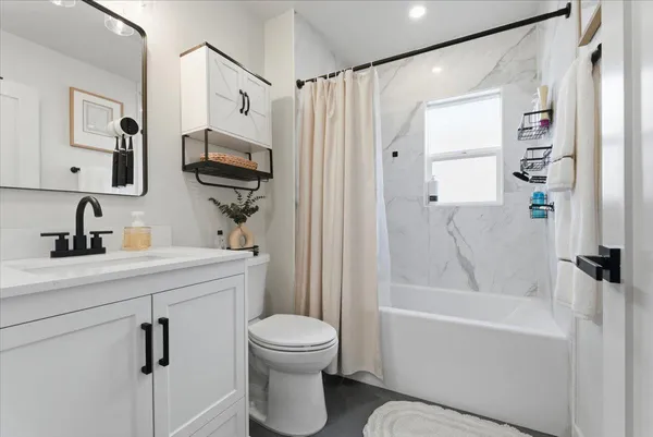 a bathroom with a sink a toilet and a bathtub