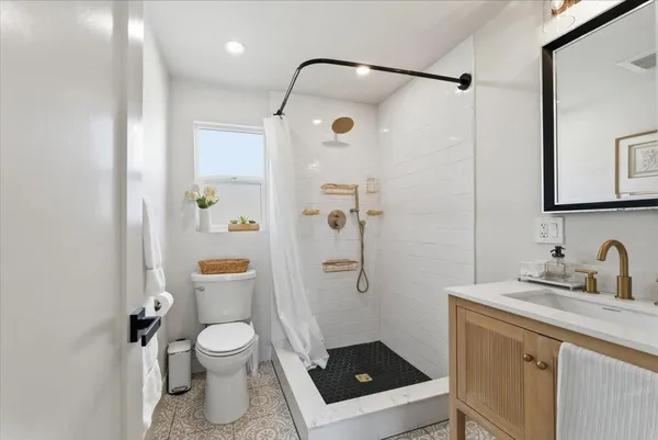 a bathroom with a toilet sink and shower