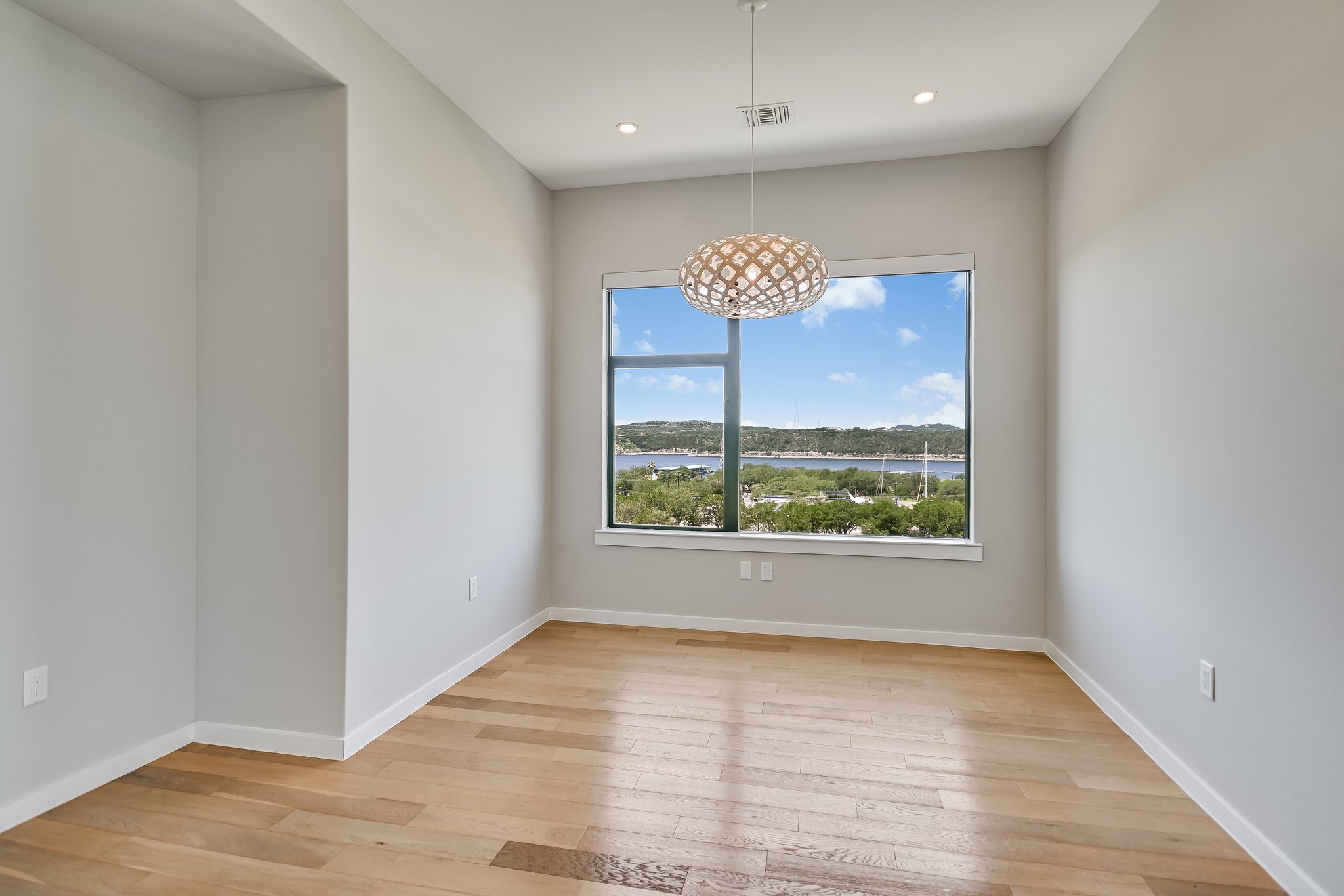 5921 Hiline Road, Unit 1501 Austin, TX 78734 - Photo 37 of 38 an empty room with wooden floor and a window