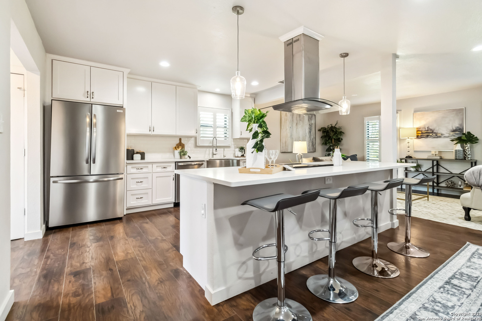 a kitchen with stainless steel appliances granite countertop a sink a stove and a refrigerator