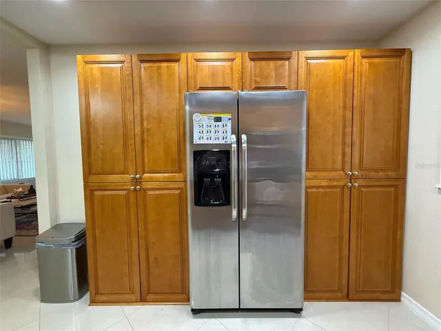a view of a refrigerator in kitchen and a window