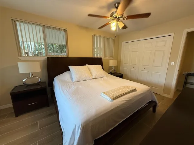 a bedroom with a bed and a window