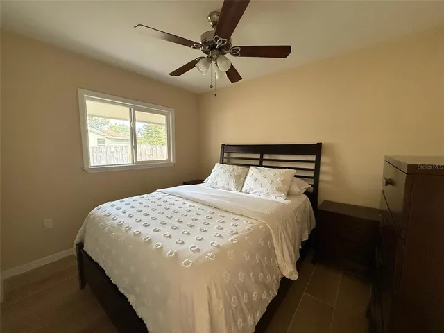 a bedroom with a bed and window