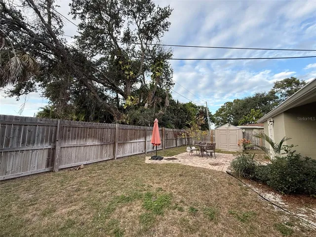 a view of backyard with trampoline