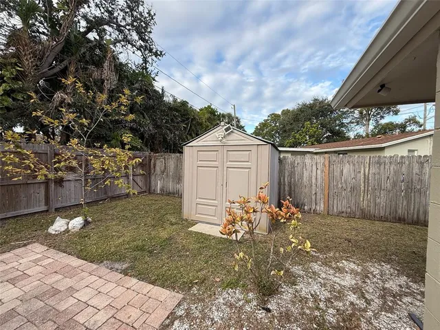a backyard of a house with table and chairs