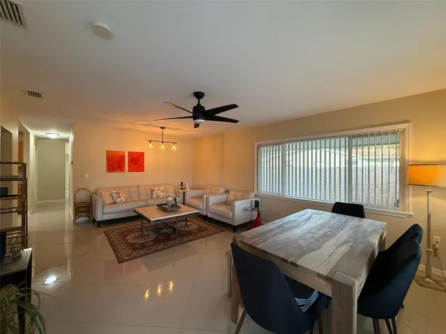 a kitchen with stainless steel appliances granite countertop a sink and a refrigerator