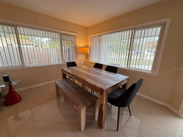 a view of a dining room with furniture and a window