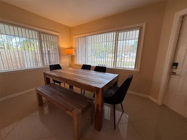a view of a dining room with furniture and window