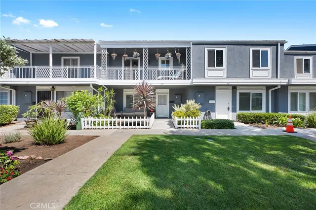 a front view of a house with garden and plants