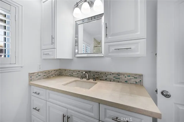 a bathroom with a sink and a mirror