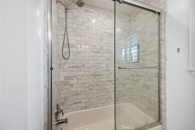 a bathroom with a glass shower door