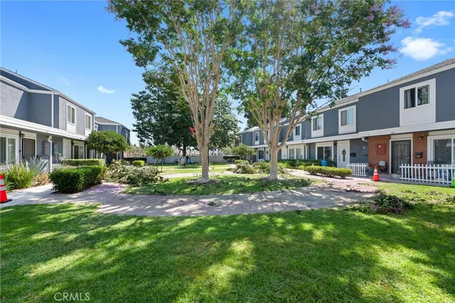 a view of a house with a yard and tree s
