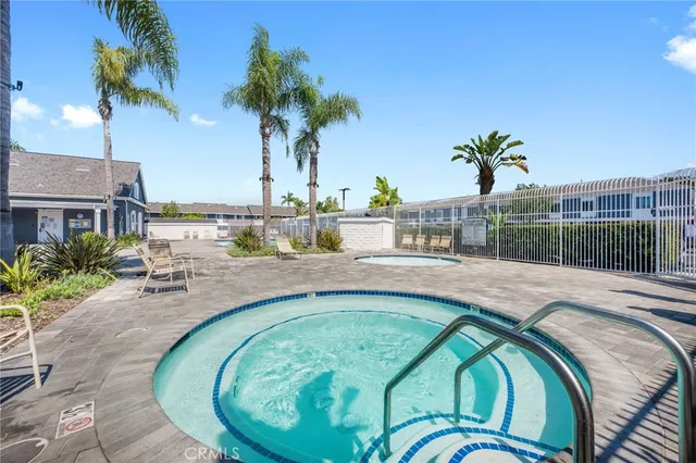 an outdoor space with swimming pool and furniture