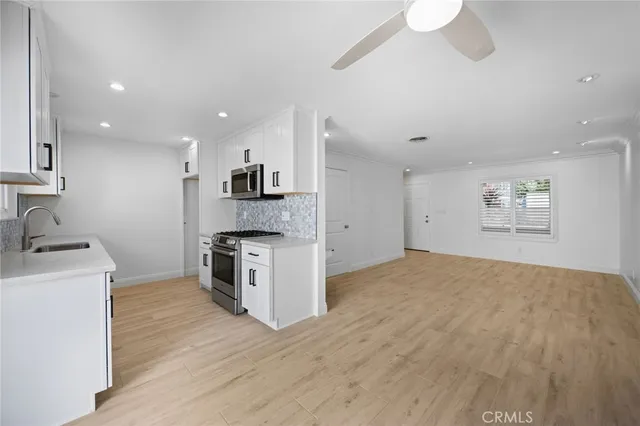 a kitchen with granite countertop a sink and a stove top oven