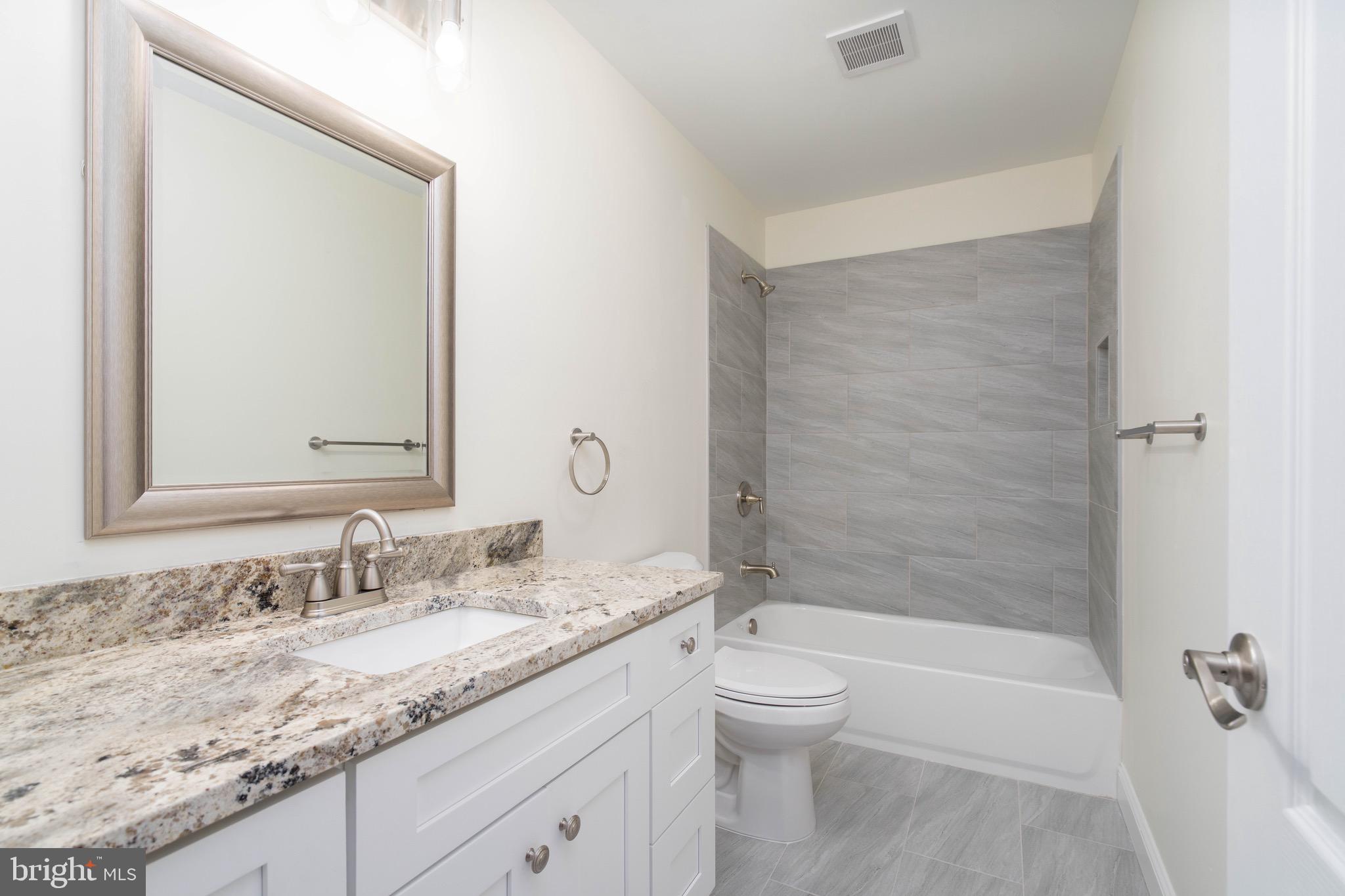 308 Gray Street Townsend, DE 19734 - Photo 18 of 33 a bathroom with a granite countertop sink a toilet and shower
