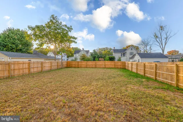 an aerial view of multiple houses with a yard