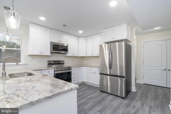 a kitchen with wooden cabinets and stainless steel appliances