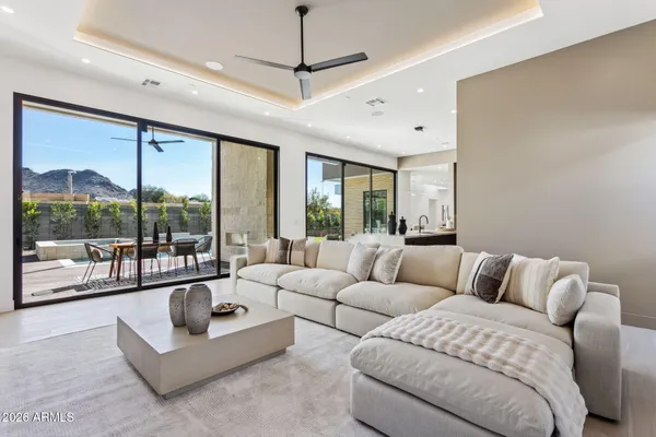 a living room with furniture and a large mirror