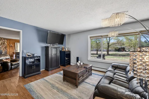 a living room with furniture and a floor to ceiling window