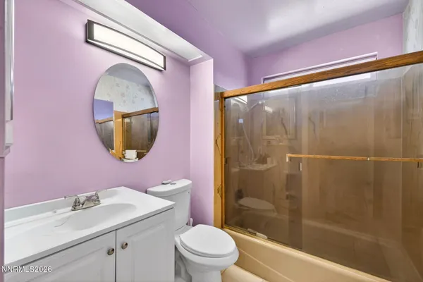 a bathroom with a sink mirror toilet and shower