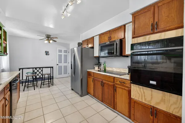 a kitchen with stainless steel appliances granite countertop a refrigerator and a stove top oven