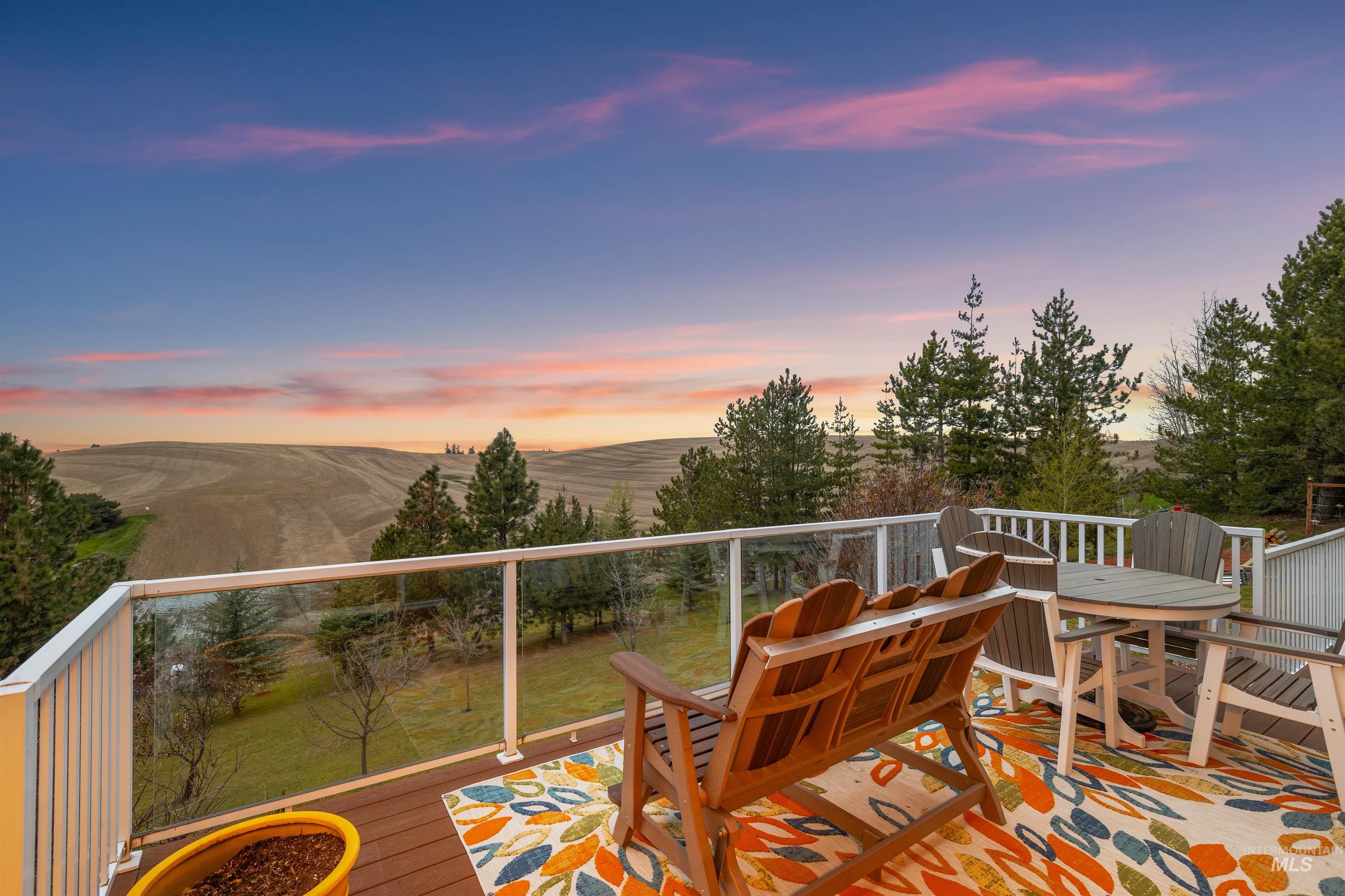 2435 Arborcrest Road Moscow, ID 83843 - Photo 4 of 50 Wooden deck featuring outdoor dining area and a mountain view