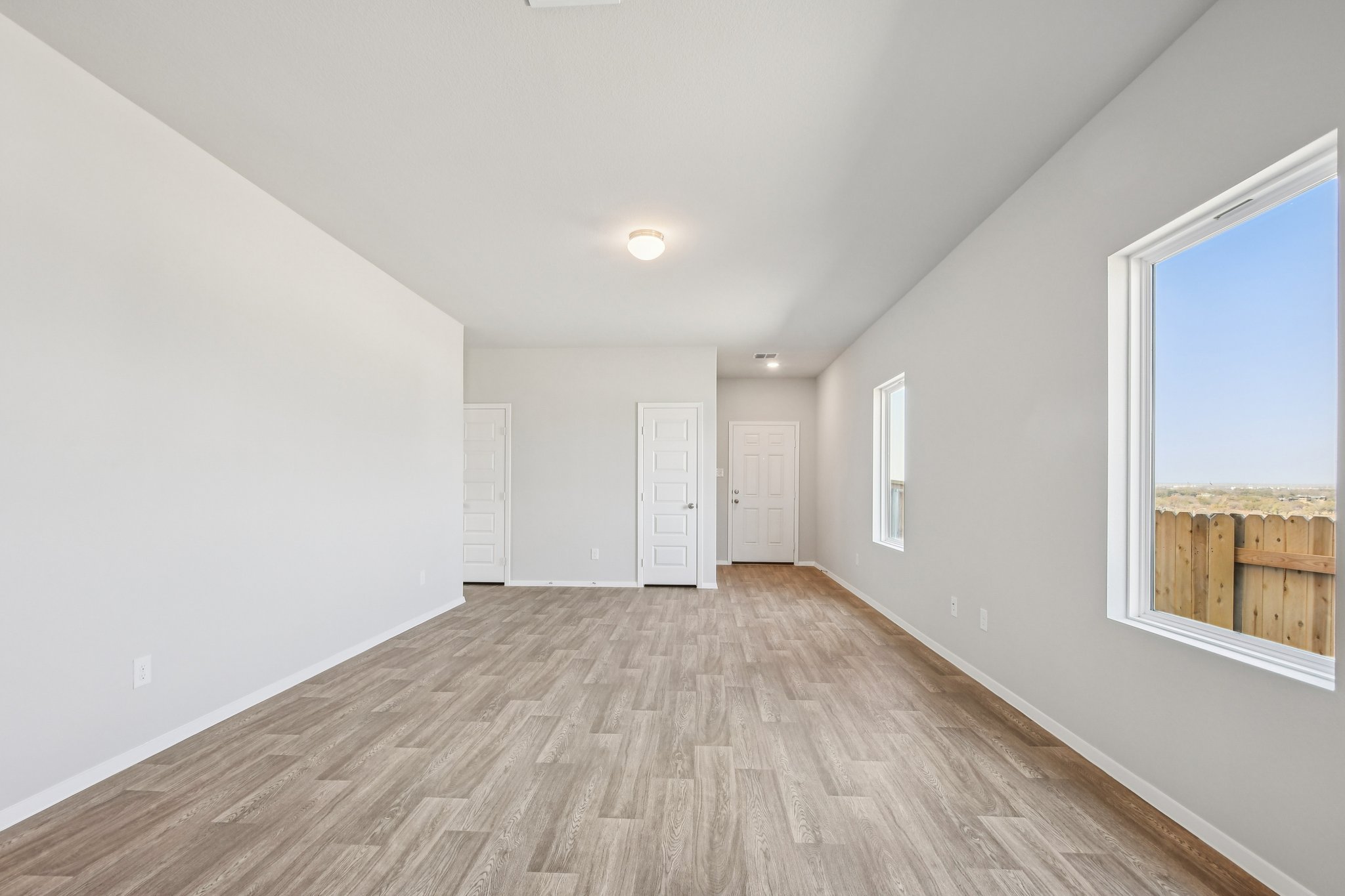 11913 Ellena Cove Austin, TX 78747 - Photo 11 of 35 a view of an empty room with wooden floor and a window