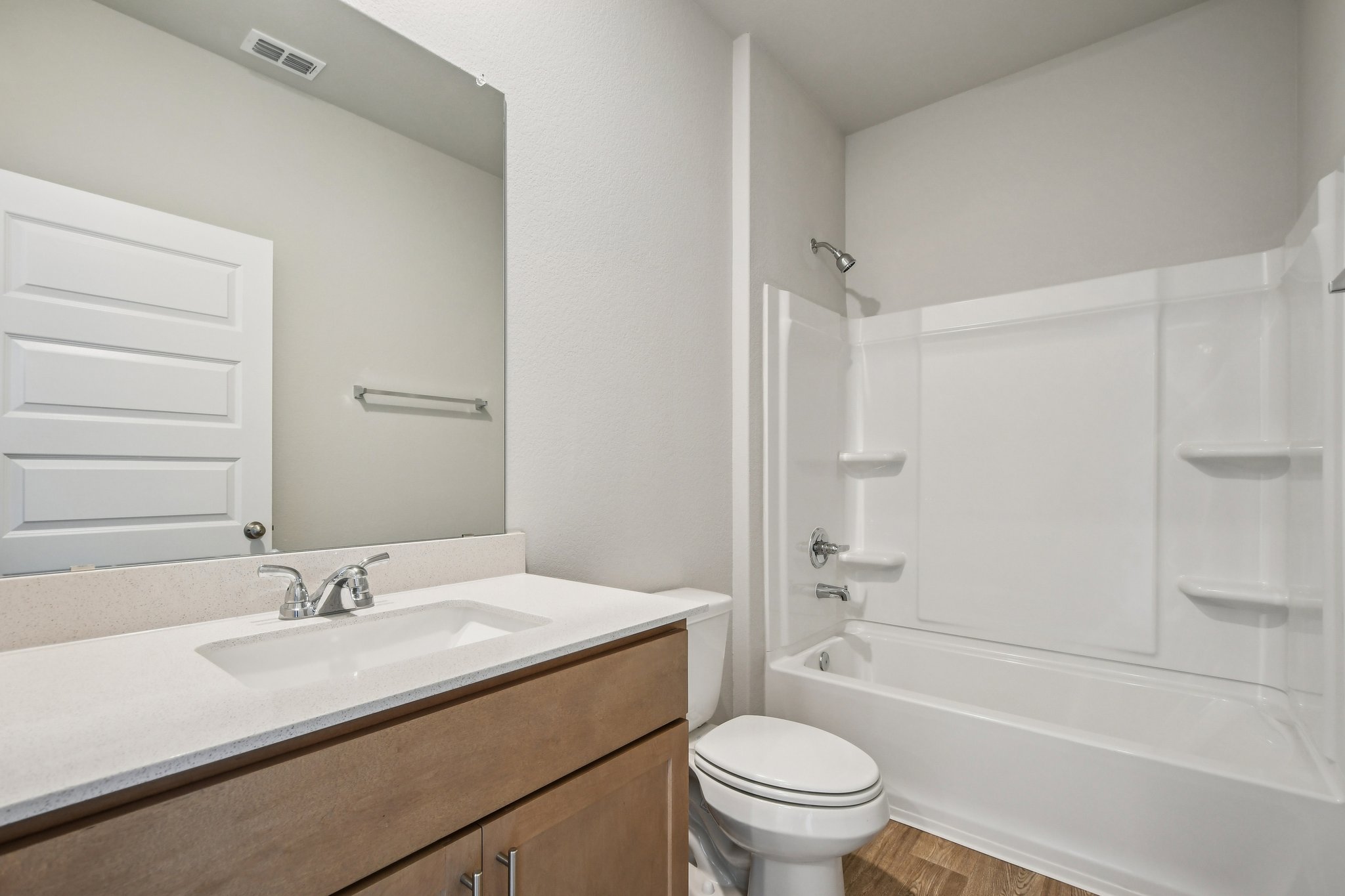 11913 Ellena Cove Austin, TX 78747 - Photo 28 of 35 a bathroom with a granite countertop sink a toilet and shower