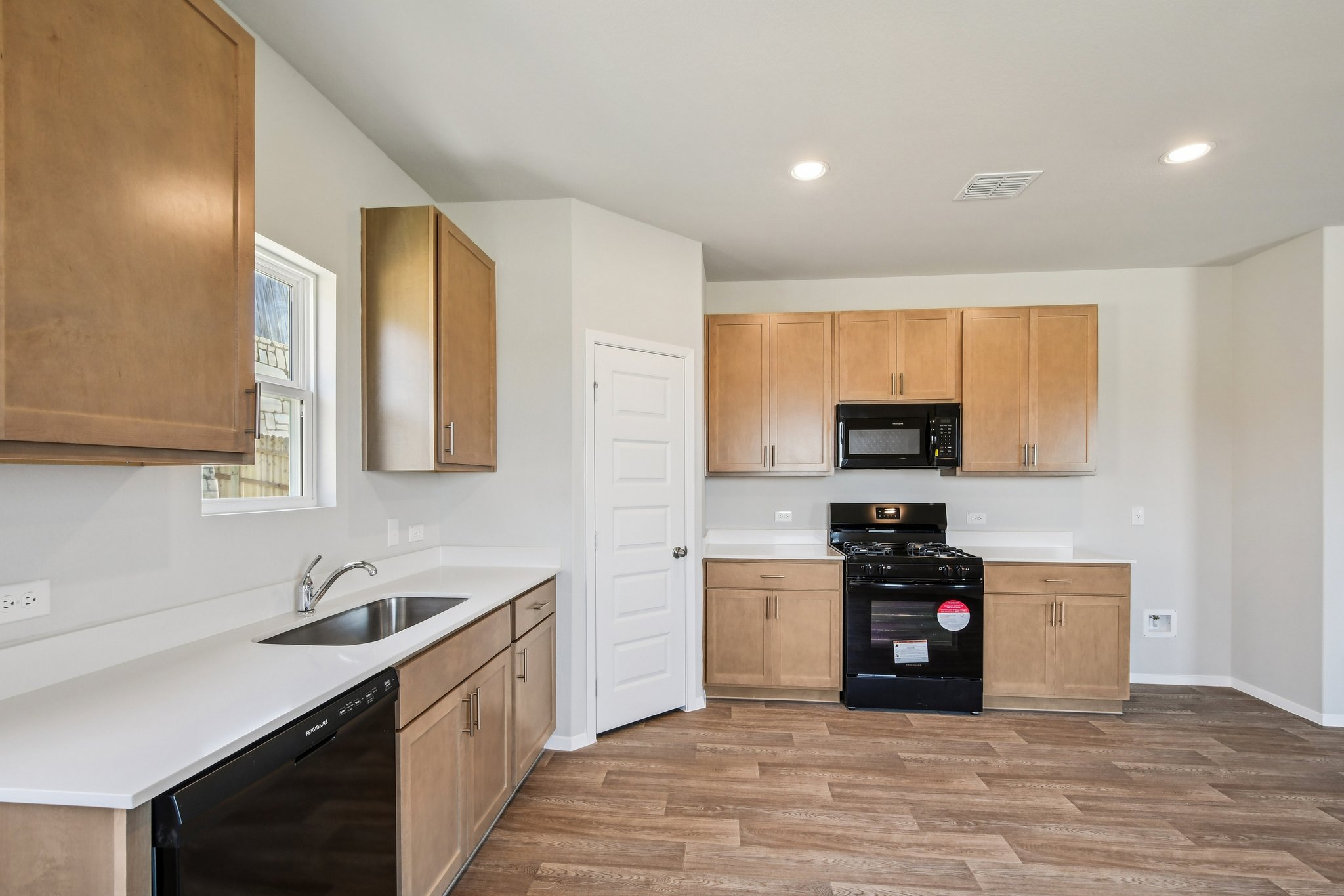 11913 Ellena Cove Austin, TX 78747 - Photo 7 of 35 a large kitchen with stainless steel appliances granite countertop a sink and a stove
