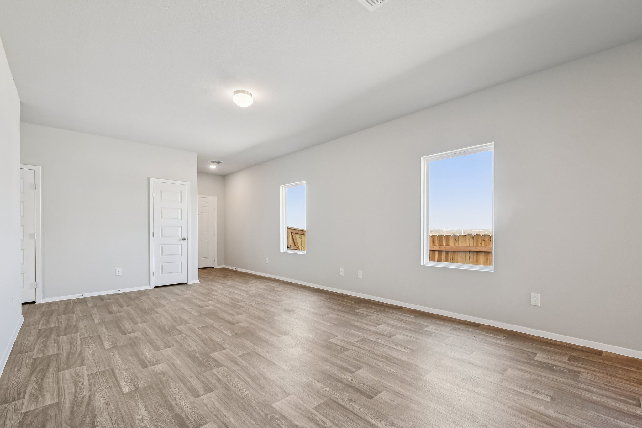 11913 Ellena Cove Austin, TX 78747 - Photo 9 of 35 a view of an empty room with wooden floor and a window