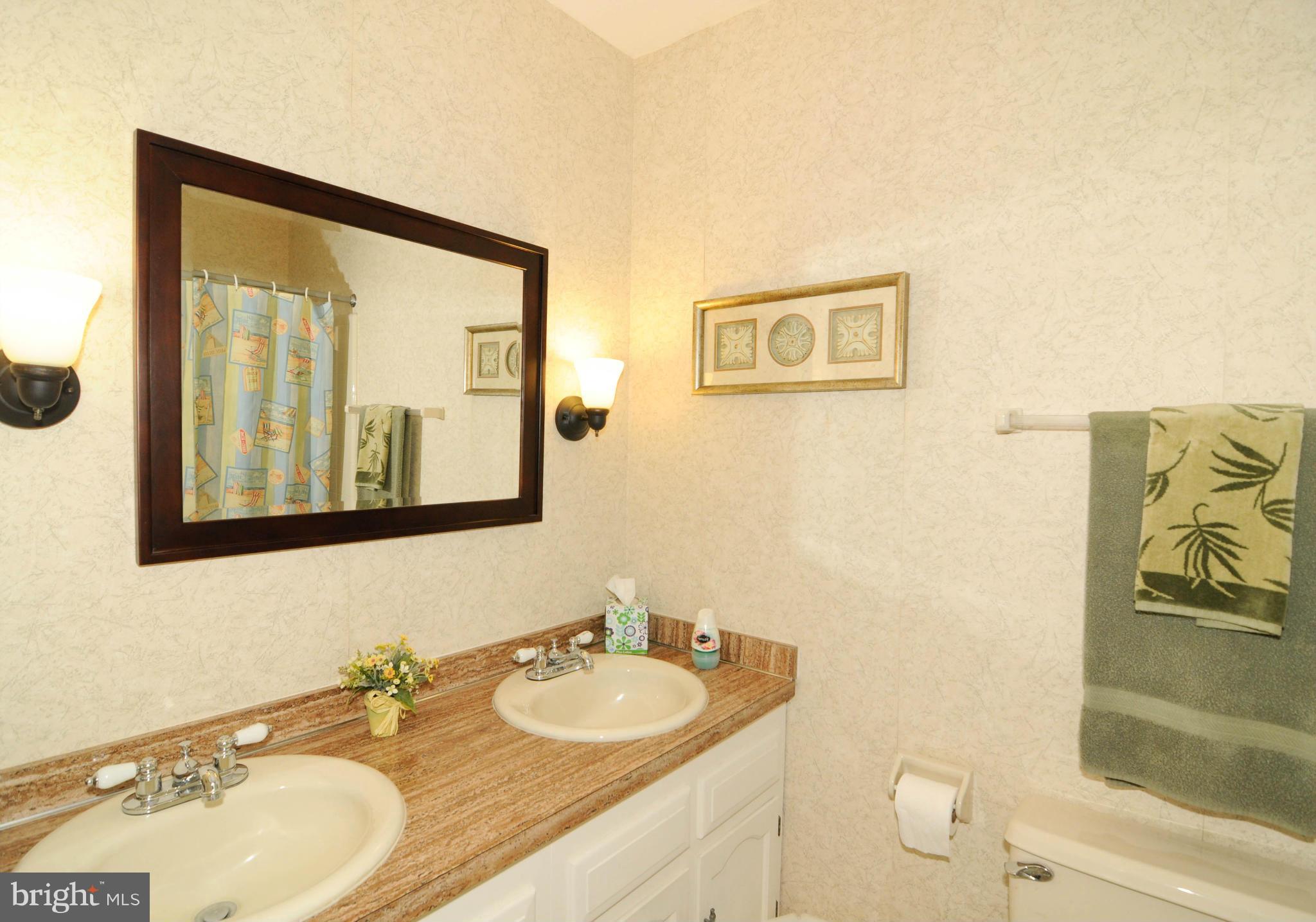 8187 Murphy Road Fulton, MD 20759 - Photo 18 of 25 a bathroom with 2 sink and a mirror