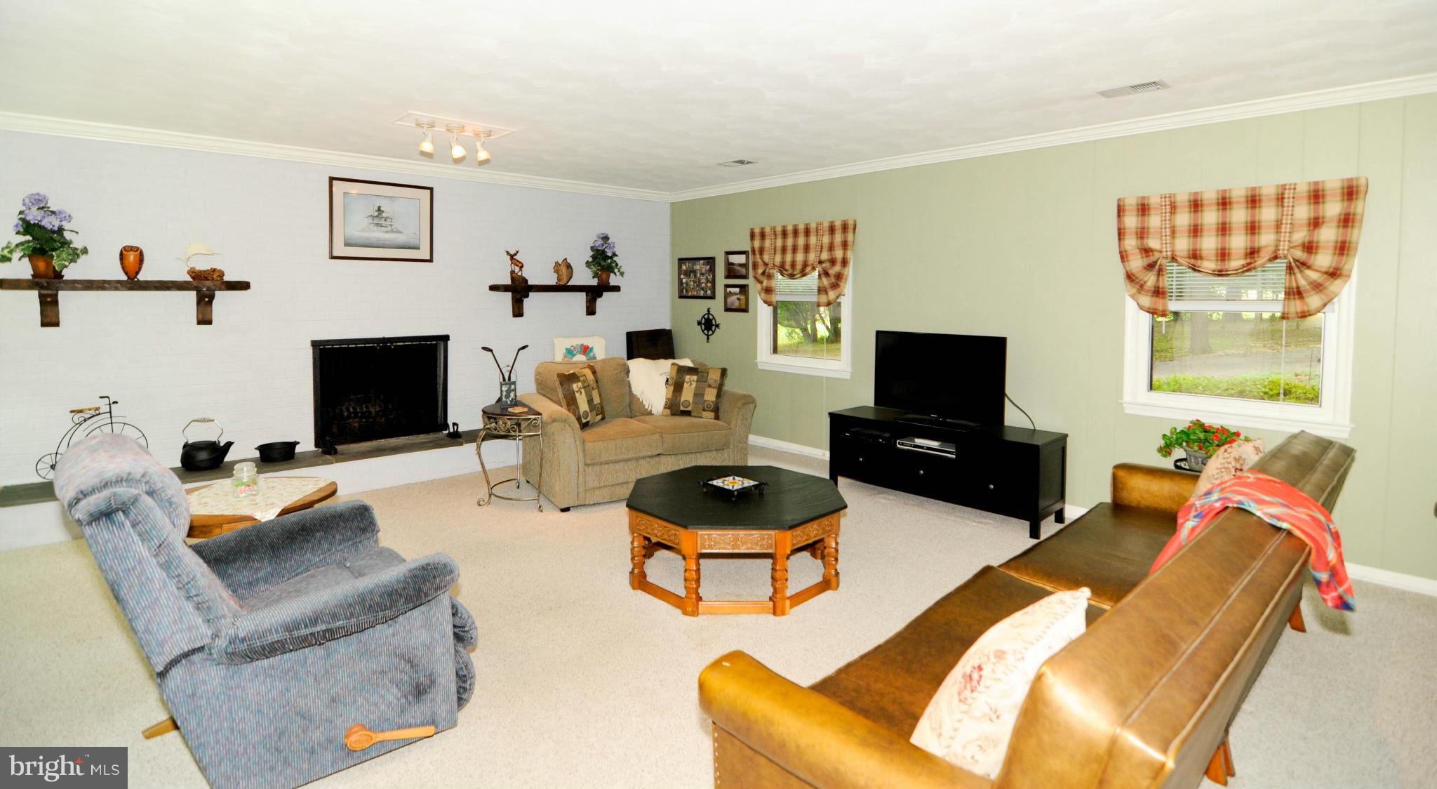 8187 Murphy Road Fulton, MD 20759 - Photo 5 of 25 a living room with furniture a flat screen tv and a fireplace