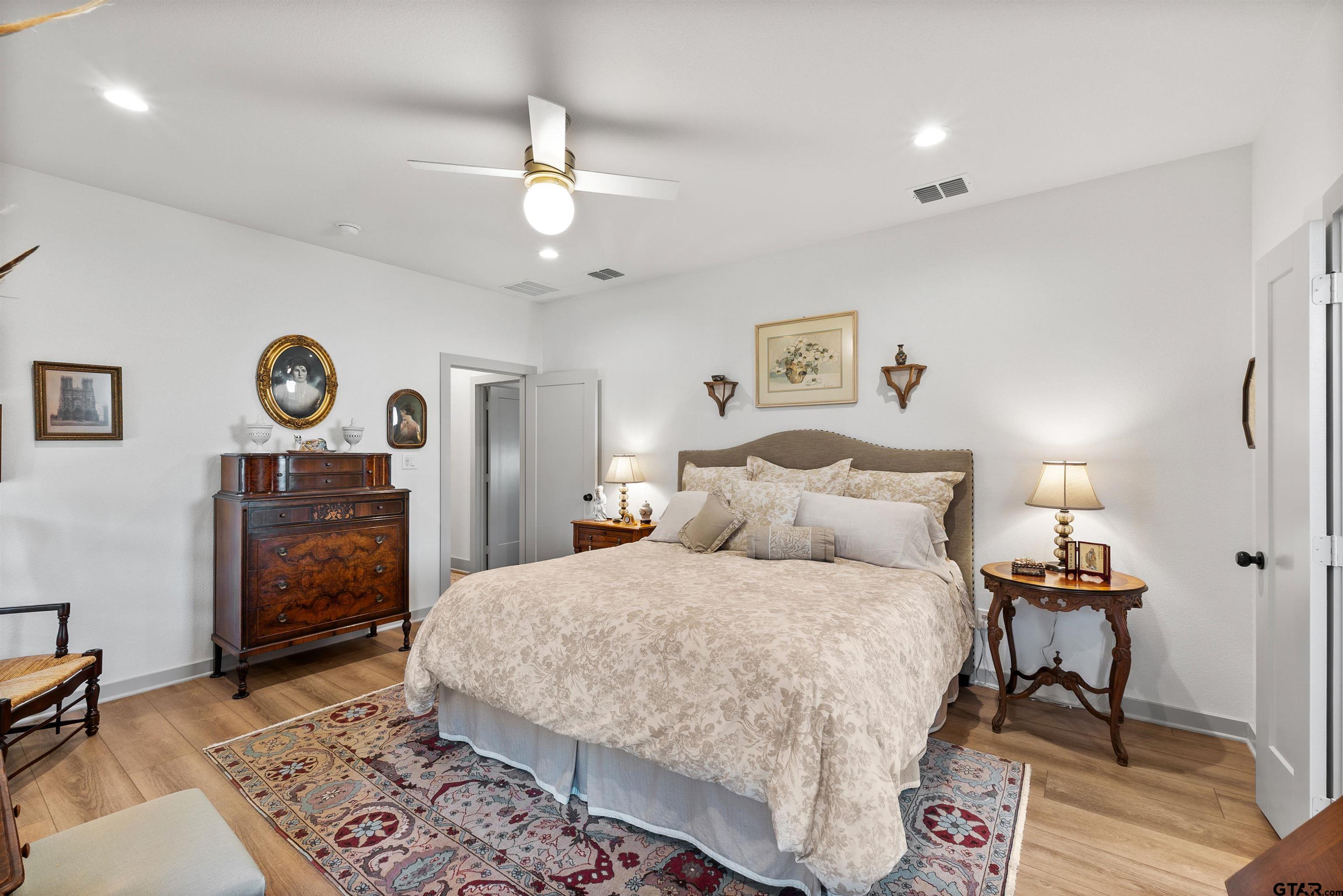242 Kaul Lane Bullard, TX 75757 - Photo 15 of 45 a bedroom with a bed and a chandelier