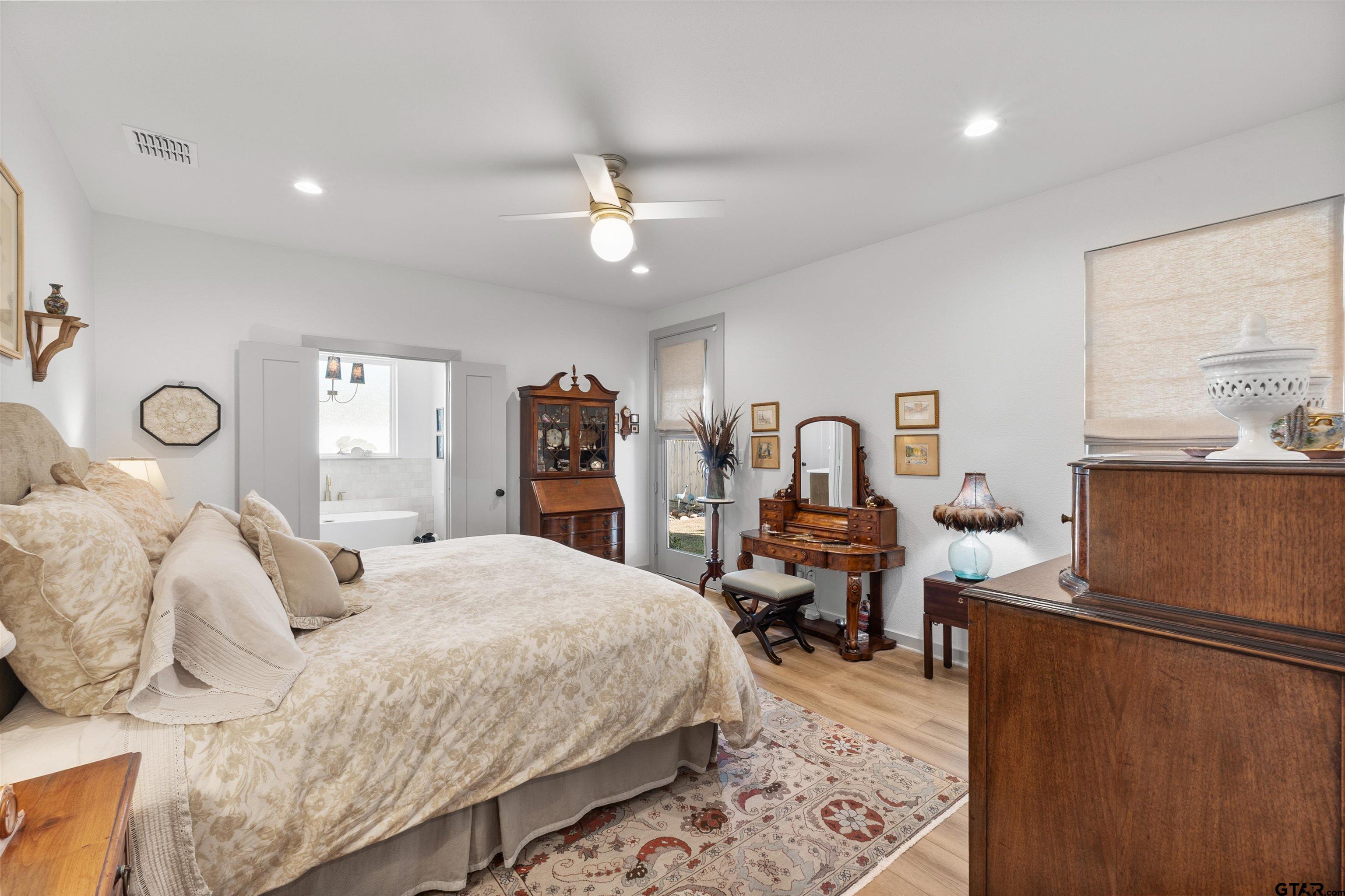 242 Kaul Lane Bullard, TX 75757 - Photo 16 of 45 a bedroom with bed and a large mirror