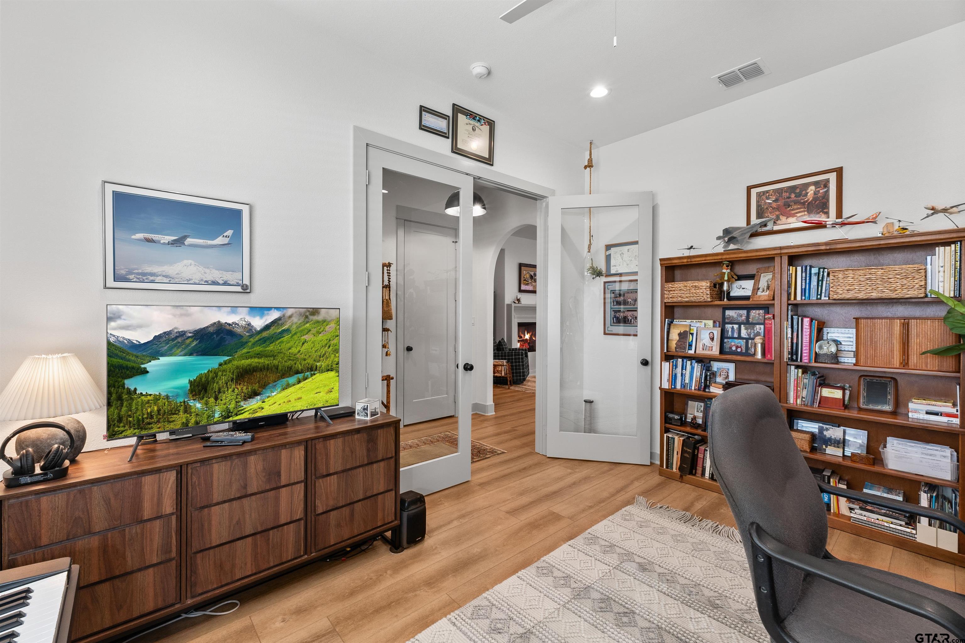 242 Kaul Lane Bullard, TX 75757 - Photo 26 of 45 a living room with furniture and a book shelf