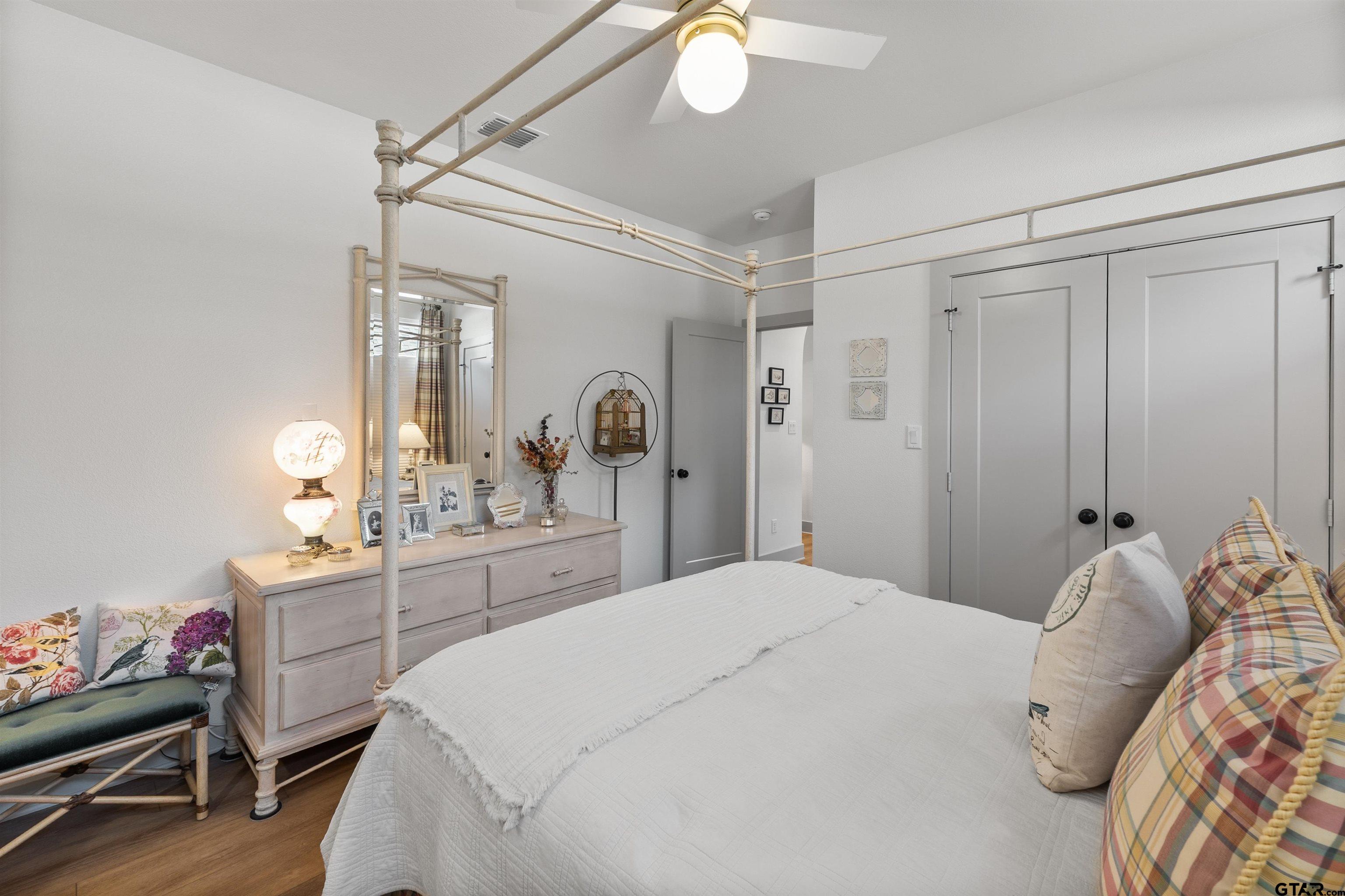 242 Kaul Lane Bullard, TX 75757 - Photo 28 of 45 a bedroom with a bed and a chandelier