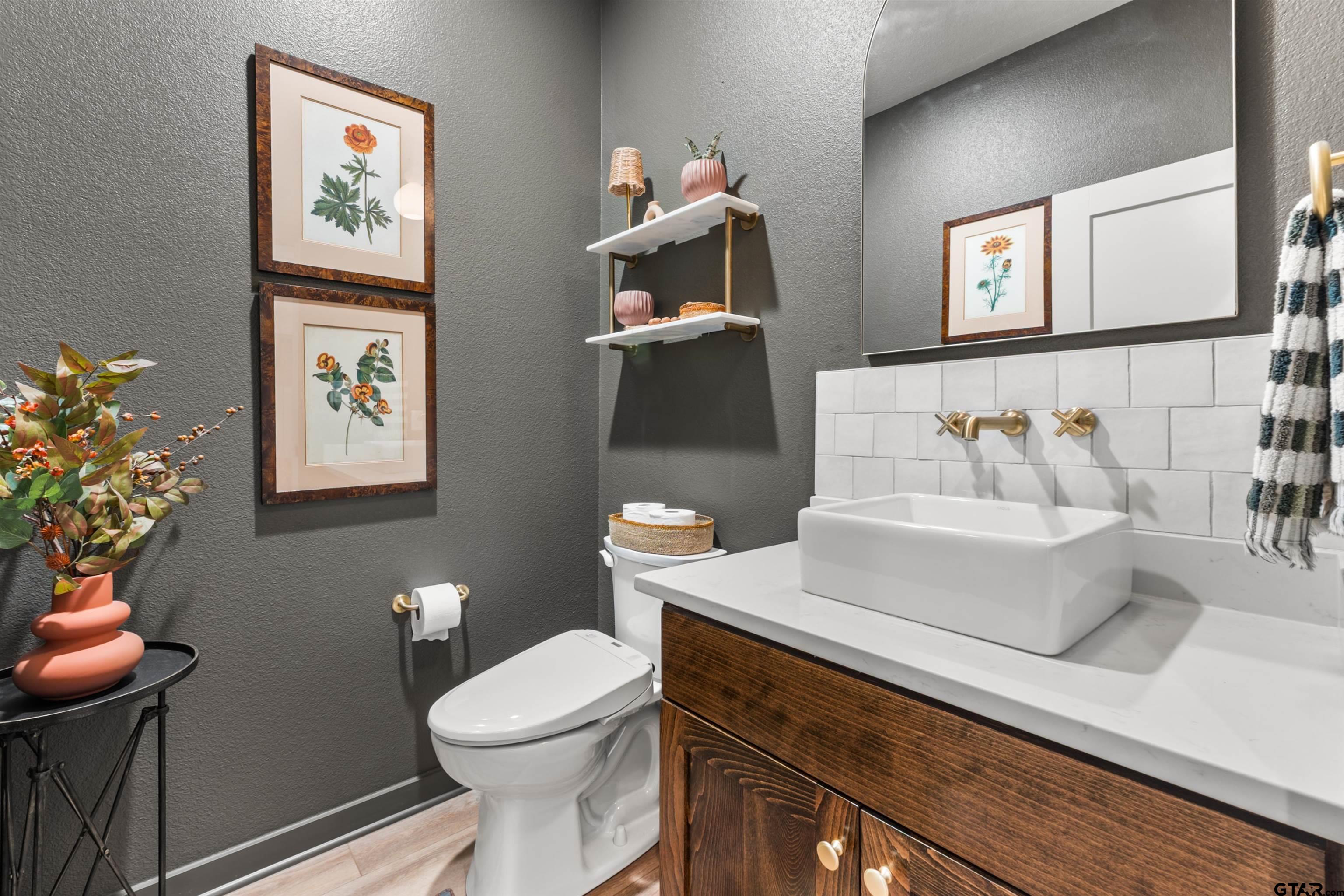 242 Kaul Lane Bullard, TX 75757 - Photo 34 of 45 a white toilet sitting next to a bathroom sink