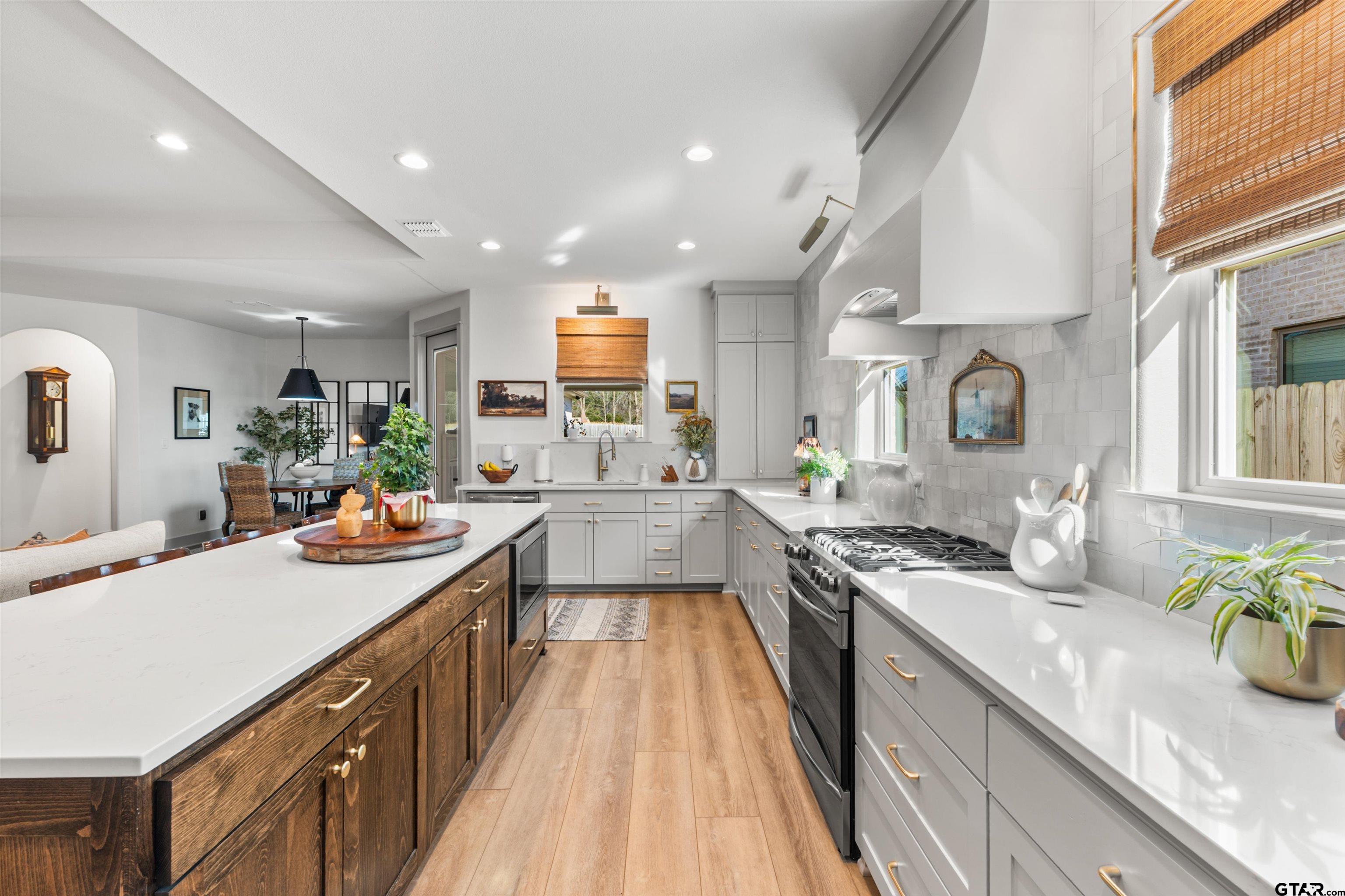 242 Kaul Lane Bullard, TX 75757 - Photo 6 of 45 a kitchen with stainless steel appliances granite countertop sink stove and cabinets
