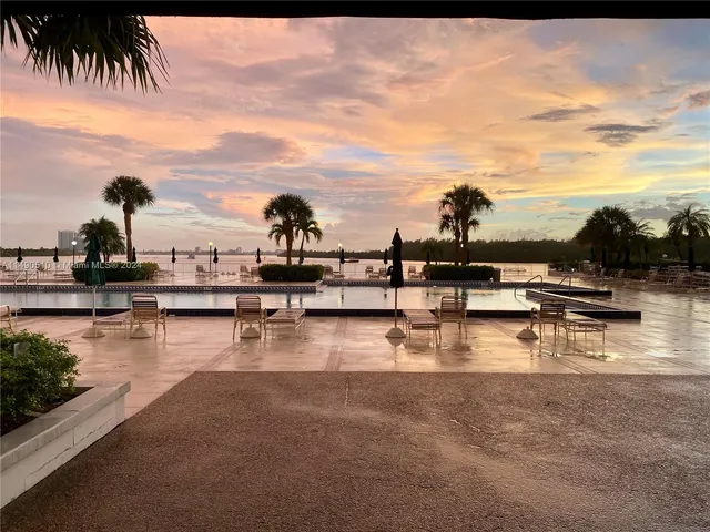 a view of swimming pool with outdoor seating and lake view