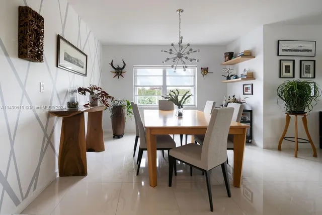 a view of a dining room with furniture and chandelier
