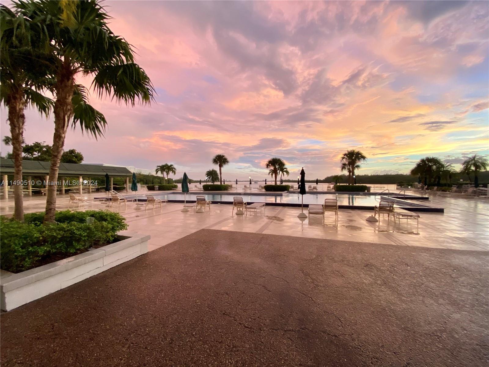 500 Bayview Drive, Unit 221 Sunny Isles Beach, FL 33160 - Photo 33 of 35 a view of swimming pool with outdoor seating and lake view