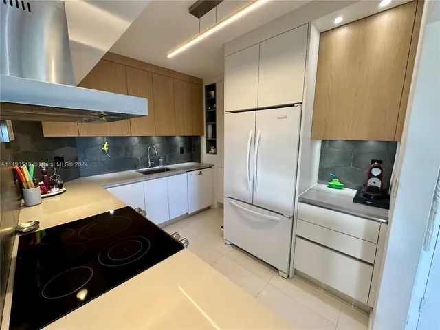 a kitchen with stainless steel appliances a refrigerator and a sink