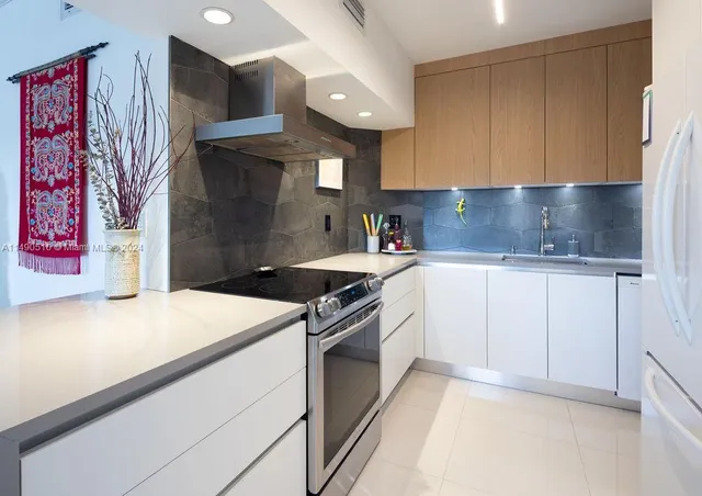 a kitchen with stainless steel appliances granite countertop a sink and a stove