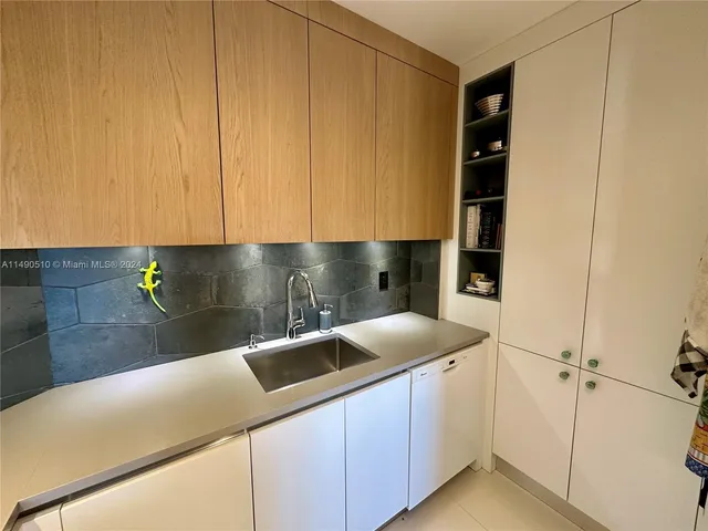 a kitchen with a sink and cabinets