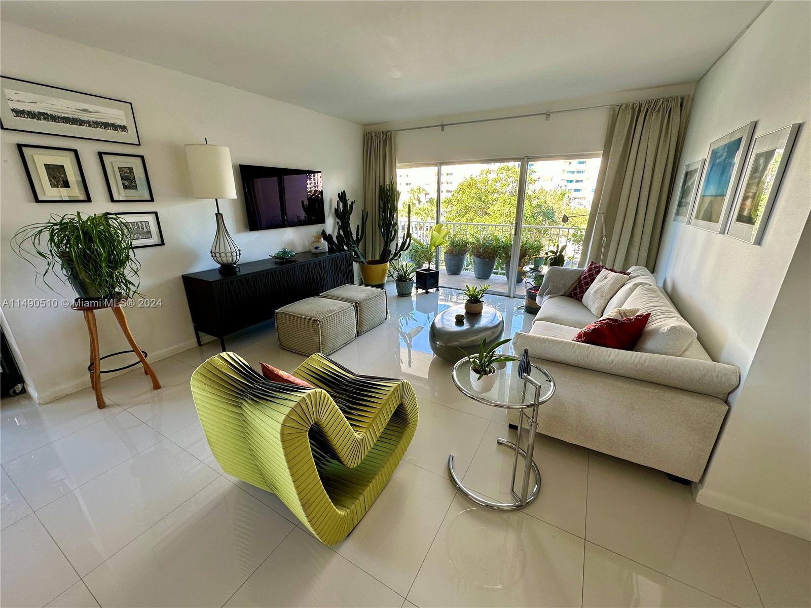 500 Bayview Drive, Unit 221 Sunny Isles Beach, FL 33160 - Photo 10 of 35 a living room with furniture and a flat screen tv