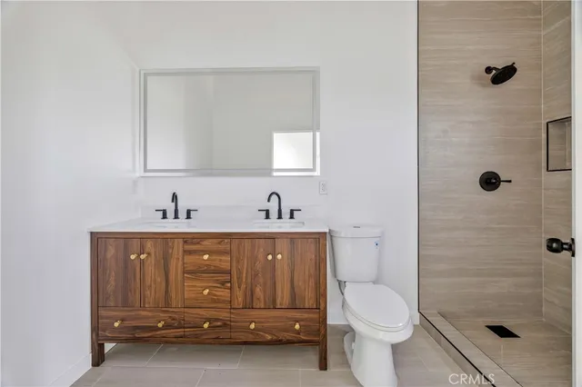a view of an empty room with closet and wooden floor
