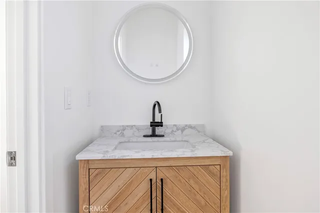 a view of a room with wooden floor and a sink