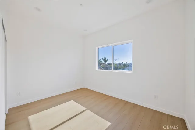 a kitchen with stainless steel appliances granite countertop a refrigerator a stove top oven a sink dishwasher and wooden floor