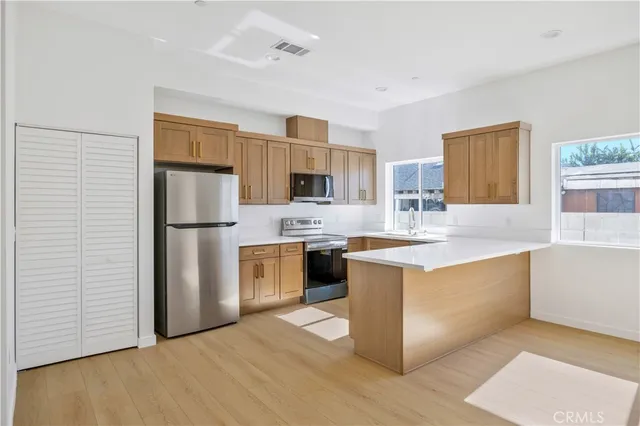 a kitchen with kitchen island a sink appliances and cabinets