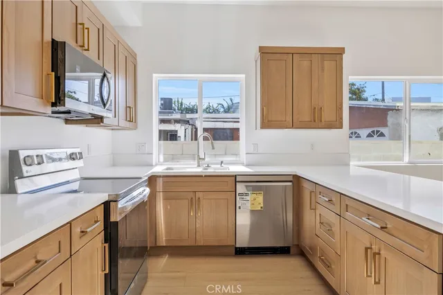 a view of a room with wooden floor and a rug